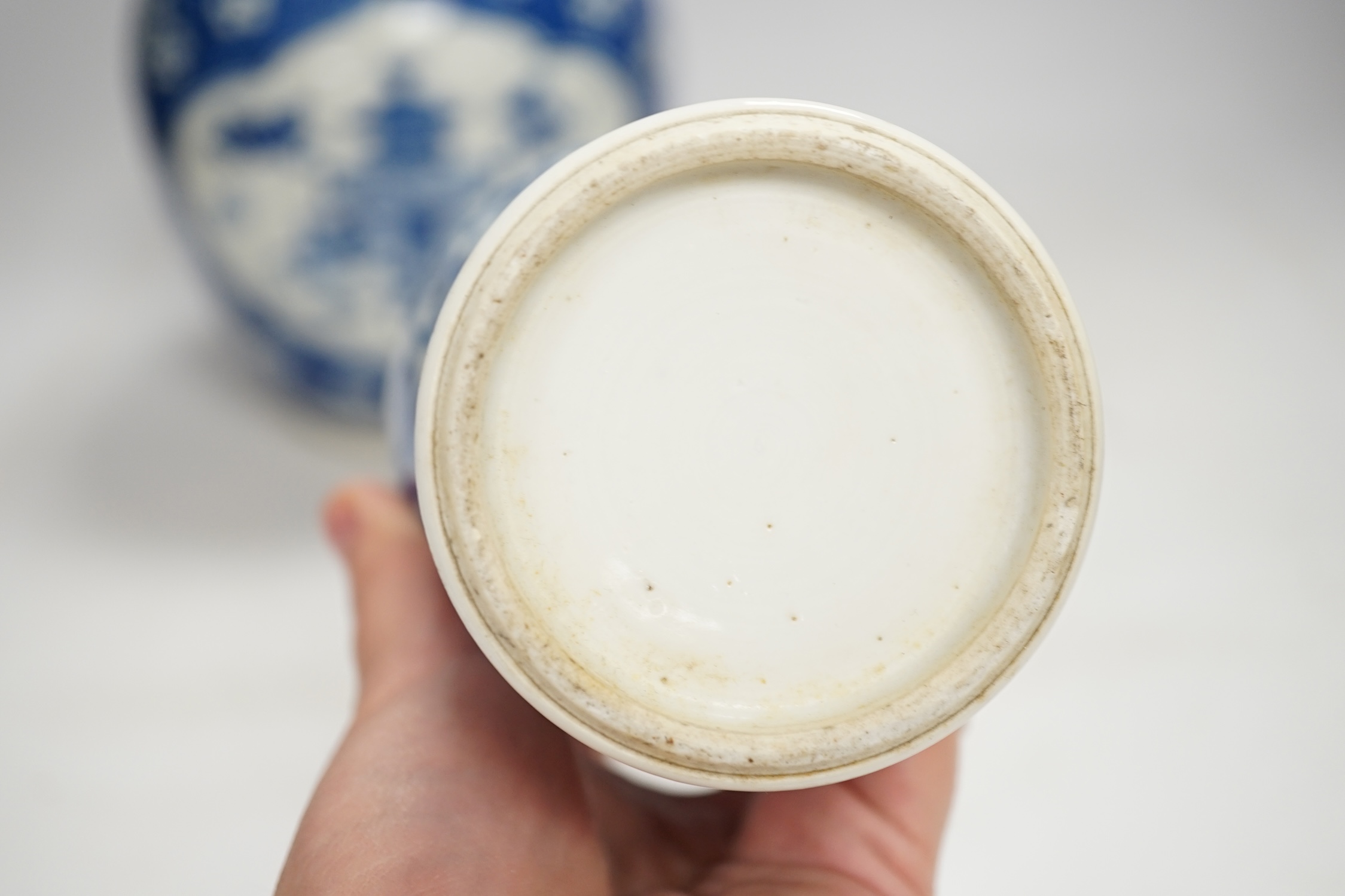 A Chinese Kangxi blue and white jar and a similar vase, jar 19.5cm high. Condition - both cracked and chipped, poor